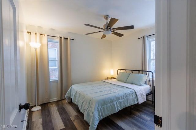 bedroom with ceiling fan and dark hardwood / wood-style floors