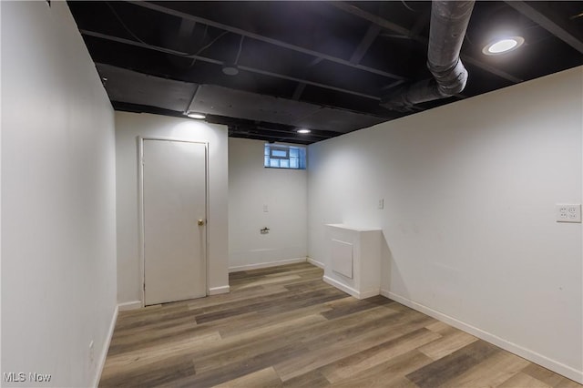 basement featuring hardwood / wood-style flooring