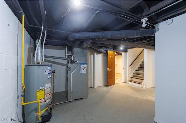 basement featuring gas water heater and heating unit