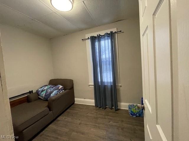 sitting room with dark wood-type flooring