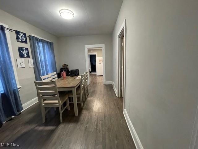 dining space with dark hardwood / wood-style flooring