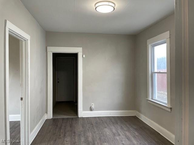 spare room featuring dark wood-type flooring