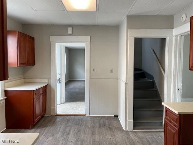 kitchen featuring wood-type flooring and a paneled ceiling