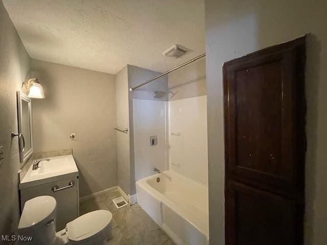 full bathroom with vanity, a textured ceiling, shower / bathtub combination, and toilet