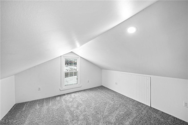 bonus room with carpet flooring and lofted ceiling