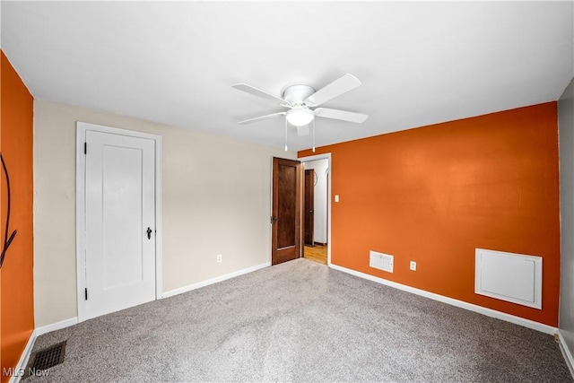 empty room with ceiling fan and light carpet