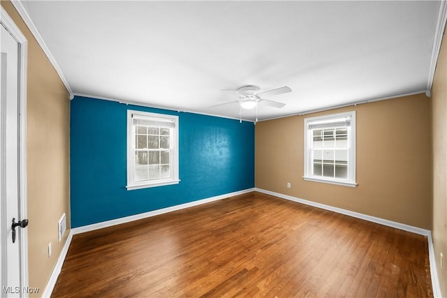 empty room with hardwood / wood-style flooring, ceiling fan, and crown molding