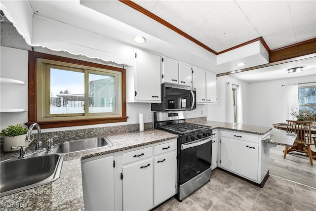 kitchen featuring sink, ornamental molding, white cabinetry, kitchen peninsula, and stainless steel appliances