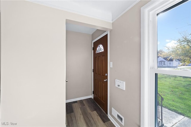 doorway to outside featuring dark hardwood / wood-style floors and ornamental molding