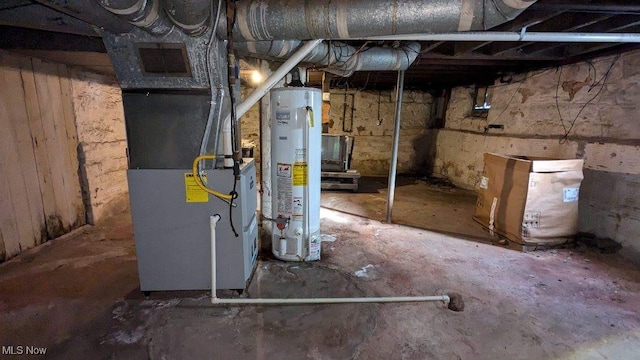 basement featuring heating unit and water heater