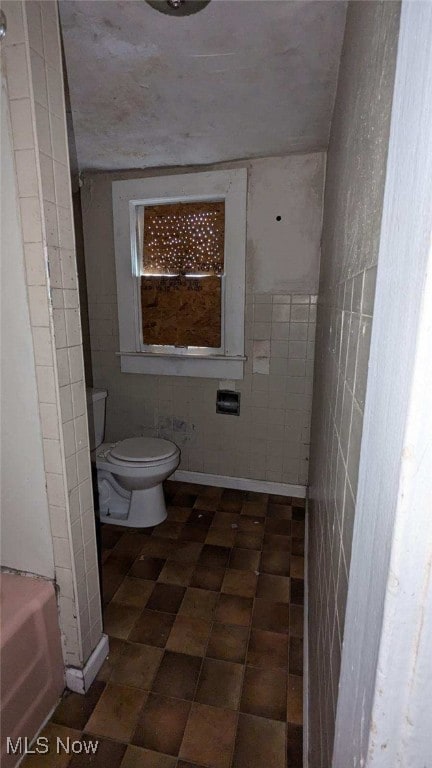 bathroom with a bathing tub and toilet