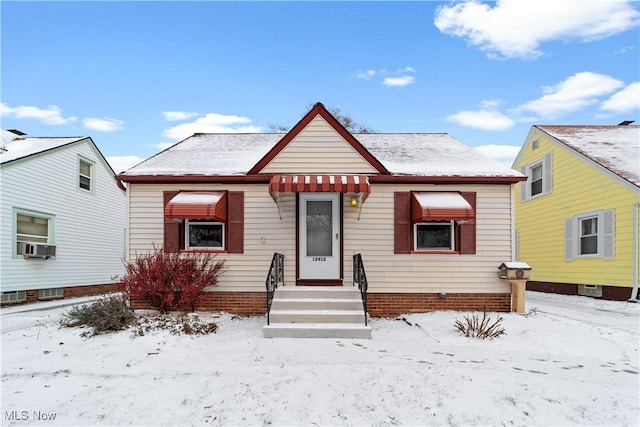 bungalow-style house featuring cooling unit