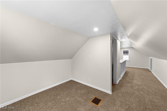 additional living space with carpet floors and lofted ceiling