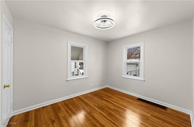 empty room with hardwood / wood-style floors