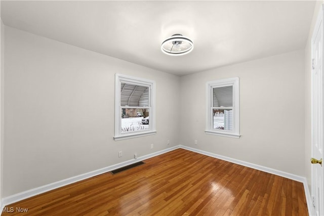 unfurnished room with wood-type flooring