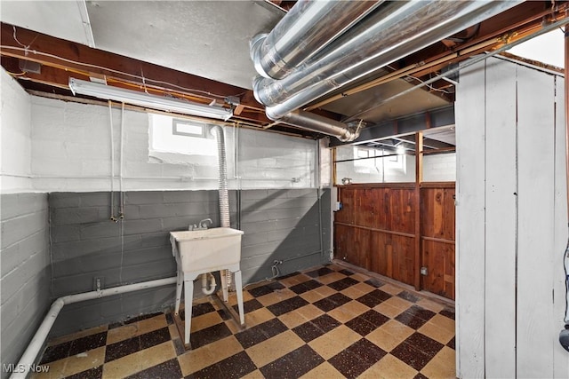 basement featuring wooden walls