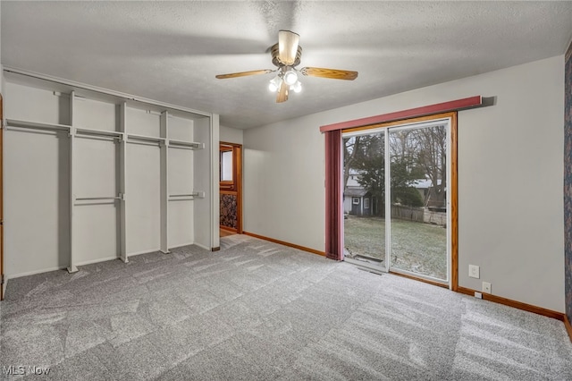 unfurnished bedroom with ceiling fan, light carpet, and a textured ceiling