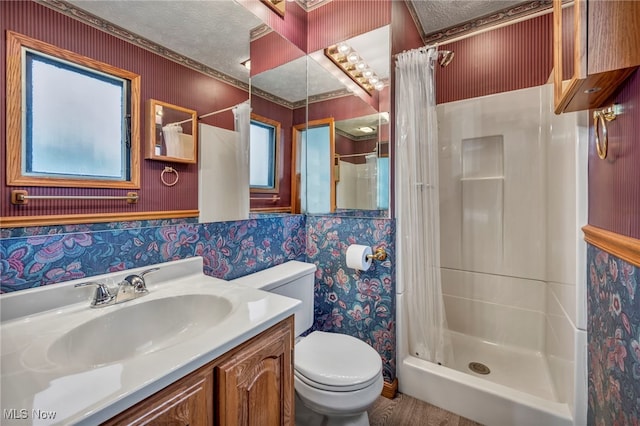 bathroom featuring a shower with curtain, vanity, a textured ceiling, and toilet