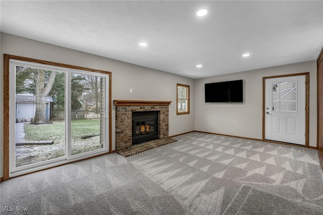 unfurnished living room with light colored carpet and a brick fireplace