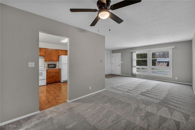 unfurnished living room with light carpet and ceiling fan