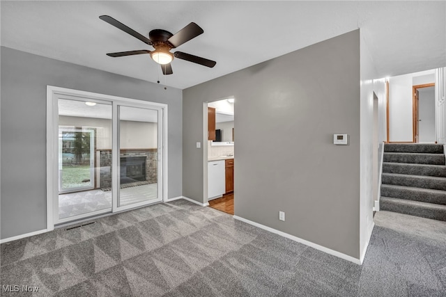 unfurnished living room with light carpet and ceiling fan