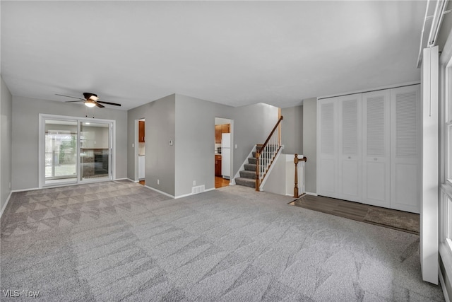 unfurnished living room with ceiling fan and light colored carpet