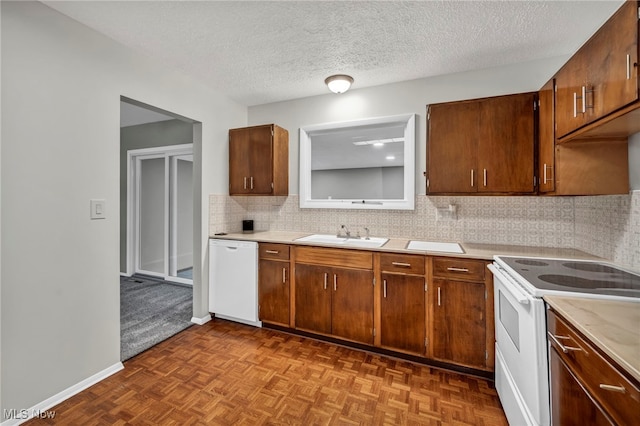 kitchen with tasteful backsplash, parquet floors, a textured ceiling, white appliances, and sink