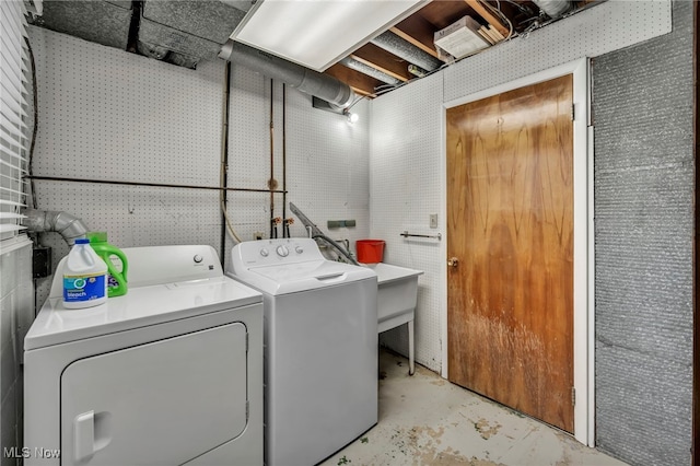 clothes washing area featuring washer and dryer