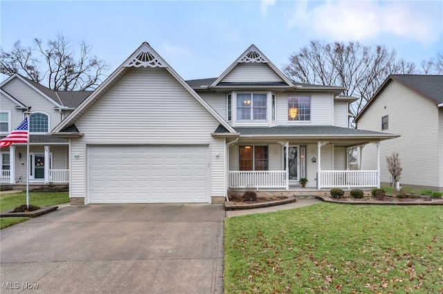 view of front of home featuring a porch, a garage, and a front lawn