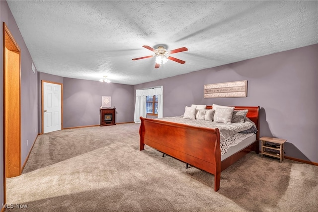 bedroom featuring ceiling fan, carpet, and a textured ceiling