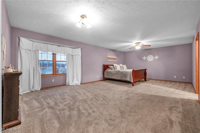 unfurnished bedroom featuring ceiling fan, a textured ceiling, and light carpet