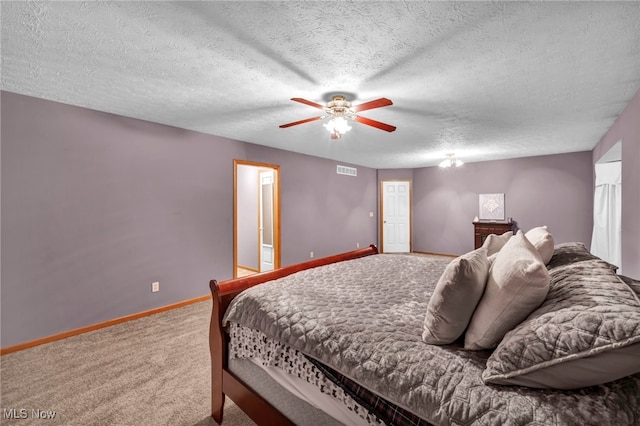 bedroom featuring carpet flooring, ceiling fan, and a textured ceiling