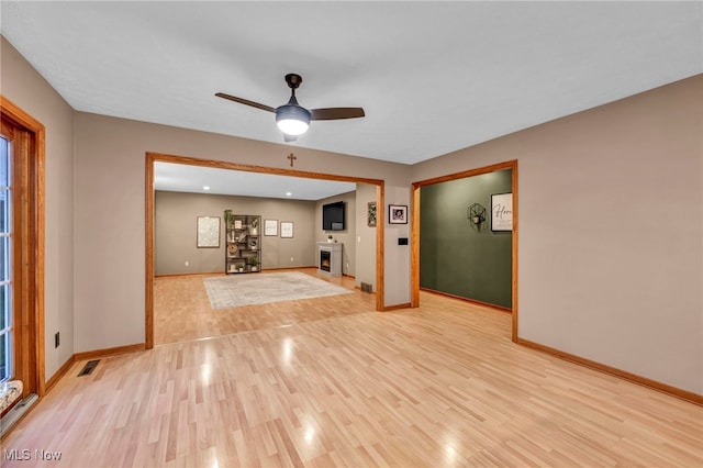 unfurnished living room with light hardwood / wood-style floors and ceiling fan