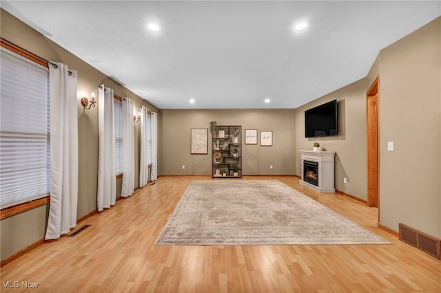 unfurnished living room featuring light wood-type flooring