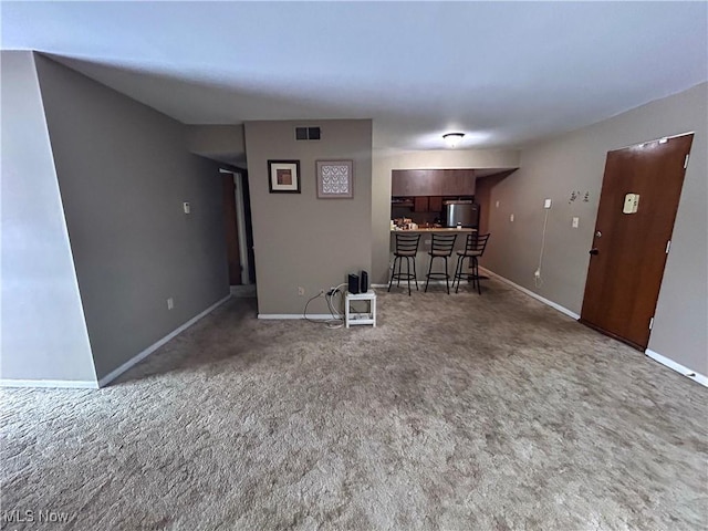 unfurnished living room with carpet flooring