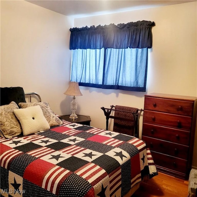 bedroom with wood-type flooring