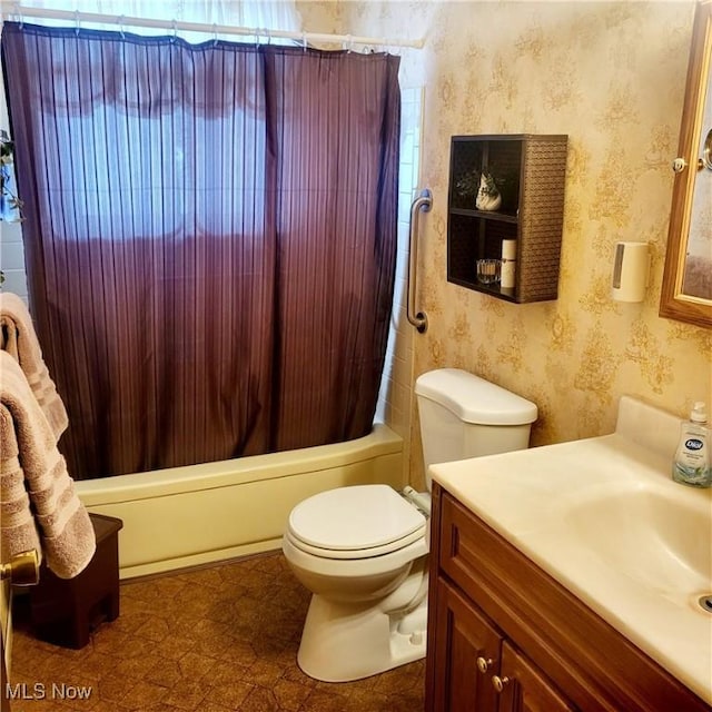 full bathroom featuring shower / bathtub combination with curtain, vanity, and toilet