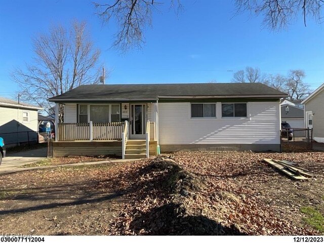 single story home featuring covered porch