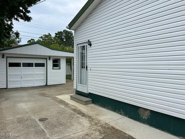 view of side of property featuring a garage and an outdoor structure