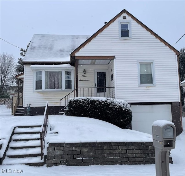 view of front of house with a porch and a garage