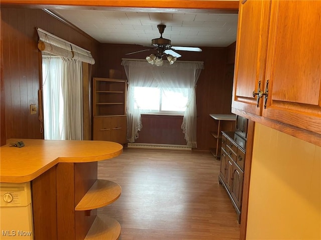 kitchen featuring ceiling fan, baseboard heating, and light hardwood / wood-style floors