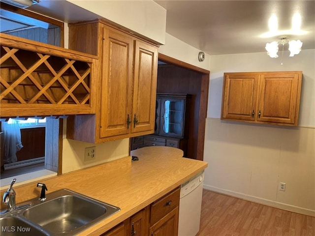 kitchen with sink, light wood-type flooring, and dishwasher