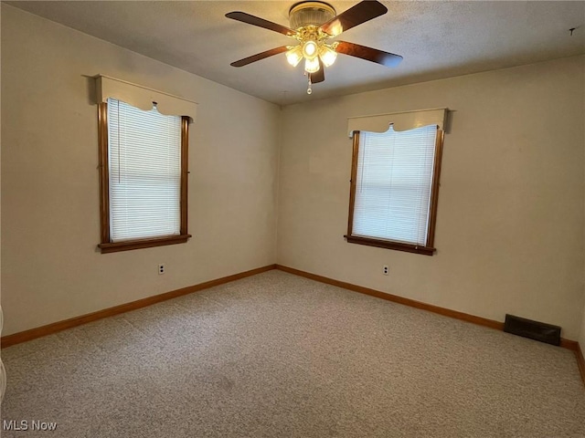 carpeted empty room with ceiling fan