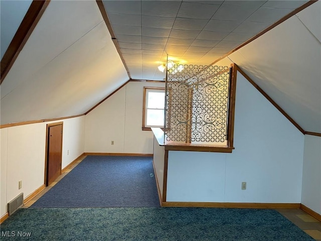 additional living space featuring lofted ceiling and carpet