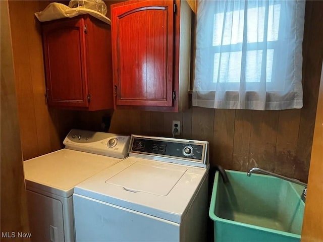 washroom featuring cabinets, separate washer and dryer, and sink