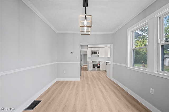 unfurnished living room with ornamental molding, light wood-type flooring, and a notable chandelier