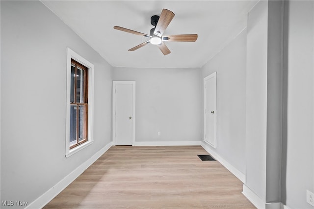 empty room with ceiling fan and light wood-type flooring