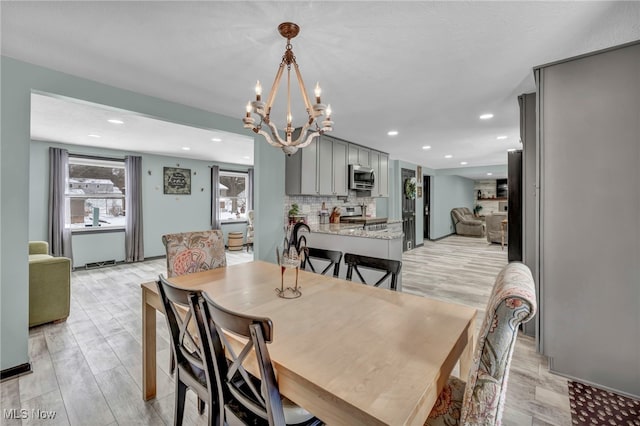 dining area featuring a chandelier and light hardwood / wood-style flooring