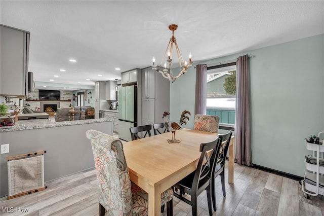 dining room with a notable chandelier and light hardwood / wood-style floors