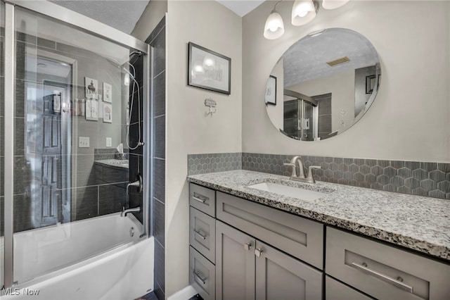 bathroom with vanity and enclosed tub / shower combo